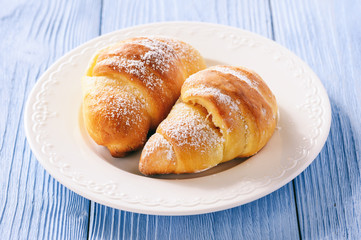 Homemade sweet croissants stuffed with cheese.