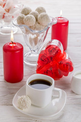 White coconut candies with cup of coffee