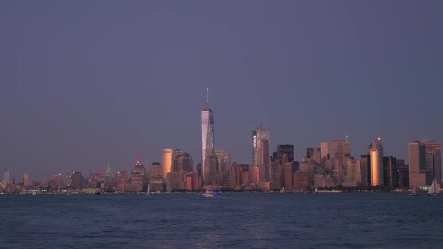 Cruising in Upper Bay overlooking iconic Lower Manhattan skyline at sunset