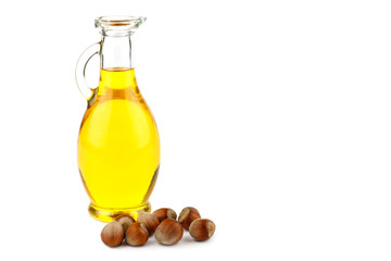Hazelnut oil in bottle and whole hazelnuts