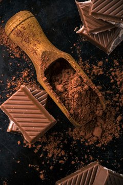 Cocoa and few pieces of chocolate with creamy filling