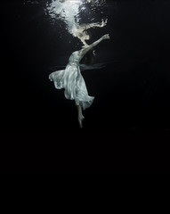Young female ballet dancer dancing underwater