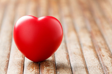 Fototapeta premium Red heart on wooden table
