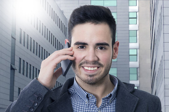 businessman smiling talking on mobile phone