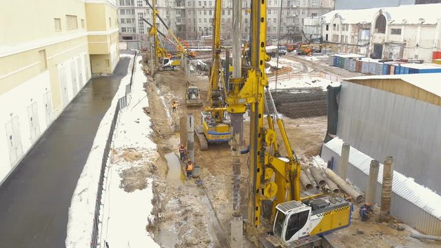 Employment of construction equipment. Drilling of wells for the pillars. Timelapse.
