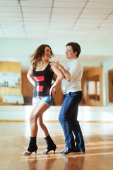 Fototapeta na wymiar Beautiful couple of professional artists dancing passionate danc