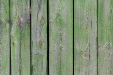 Old green wooden fence. Backgrounds and textures