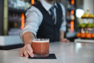 Waiter serving drink