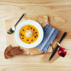 Pumpkin soup in white bowl, dietary vegetable