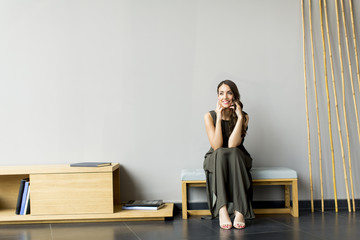 Young woman sitting on the chair in the room