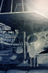 Lower part and big propeller of a fishing boat in shipyard for maintenance.Local shipyard in Southeast Asia ,color toned.