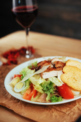 Caesar salad with croutons, quail eggs, cherry tomatoes and gril