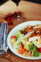 Caesar salad with croutons, quail eggs, cherry tomatoes and gril