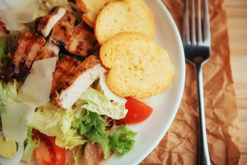 Caesar salad with croutons, quail eggs, cherry tomatoes and gril