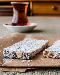 Turkish Dessert Cezerye with walnut, coconut powder and tea