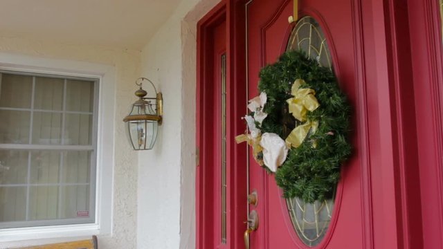 Christmas Wreath Hanging On A Red Door