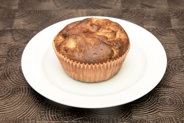 Fresh hand made muffins on dark wooden background