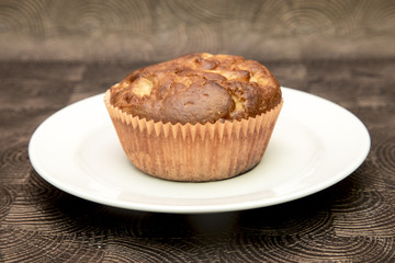 Fresh hand made muffins on dark wooden background