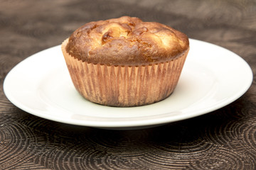 Fresh hand made muffins on dark wooden background