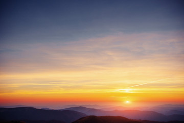 Naklejka na ściany i meble colorful sky with sun background in mountains. sunset, sunrise
