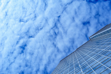 glass office building skyscraper on a background of clouds