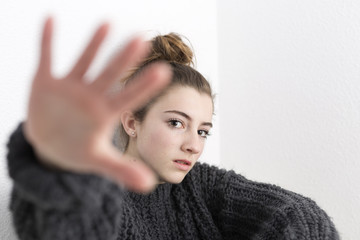 Fototapeta premium Young woman with hand raised on a white background.