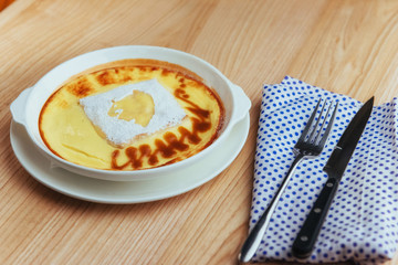 Delicious cheese casserole in a ceramic pot.