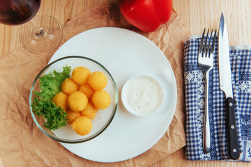 Deep fried cheese balls with lettuce and sauce