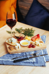 Red Wine And Assorted Cheese Plate with fruit