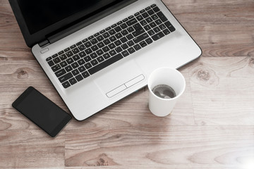 Office workplace with coffee and note book on wood table.