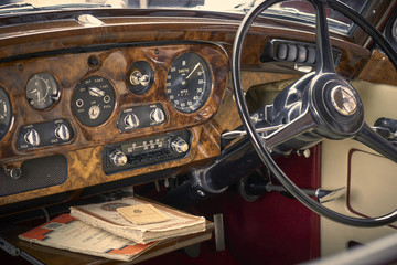 Vintage car dashboard with walnut and chrome