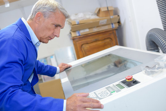 Man looking into cabinet with glass lid