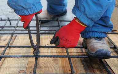 Construction worker working on steel rods used to reinforce concrete