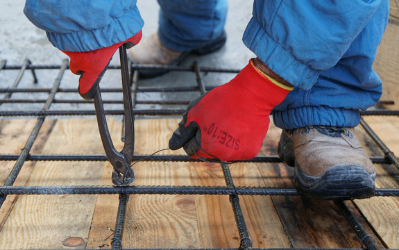Construction worker working on steel rods used to reinforce concrete