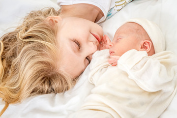 newborn baby and sister at home, indoor portrait