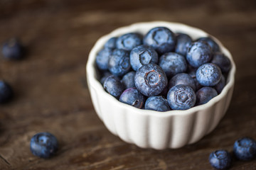 Blueberries in a Bowl on Wooden Background