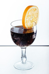 glass of wine with orange on a white background.
