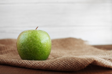Green apple on sacking. The concept of healthy eating and vegetarianism.