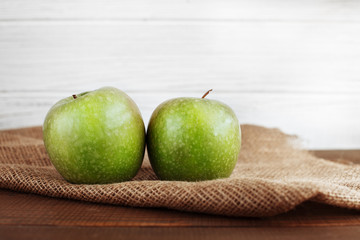 Two green apples on a sacking. The concept of healthy eating and vegetarianism.