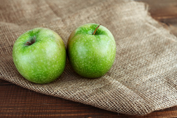 Two green apples on the table. The concept of healthy eating and vegetarianism.