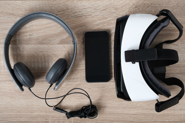 Top view VR virtual reality glasses, headphones and  smart phone