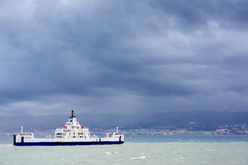 Fototapeta na wymiar ship at sea under dramatic clouds Sicily Italy Europe