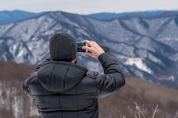 Hiker makes photo of mountains