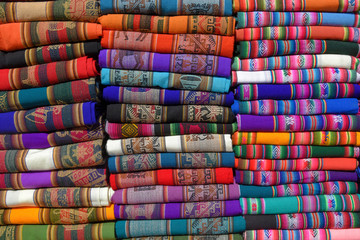 A pile of colorful rugged Peruvian textile and fabrics.