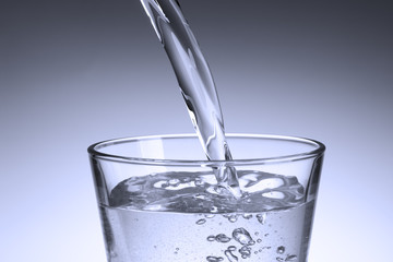 Pouring sparkling water into a glass