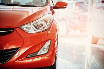 Headlights and hood of sport red car.