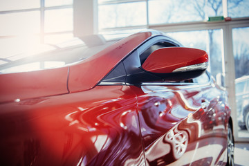 Fototapeta premium Headlights and hood of sport red car.