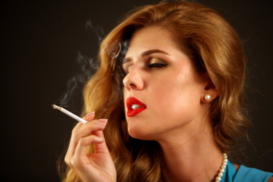 woman smokes cigarette Woman Smoking Cigarette