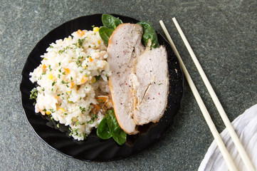 Chicken with rice and vegetables on a plate