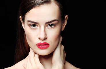 Portrait of beautiful young woman on black background, close up